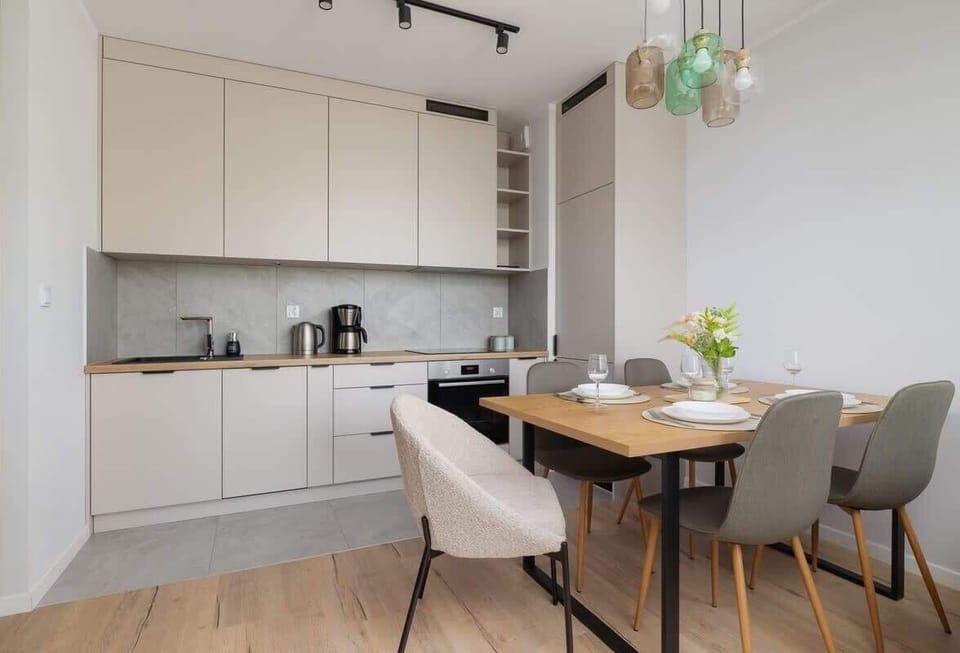 Functional and bright kitchen-dining area blending practical design with a soft, homey atmosphere.
