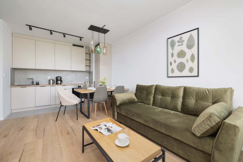 Chic and inviting living area with soft lighting and a fresh palette of green and beige tones.