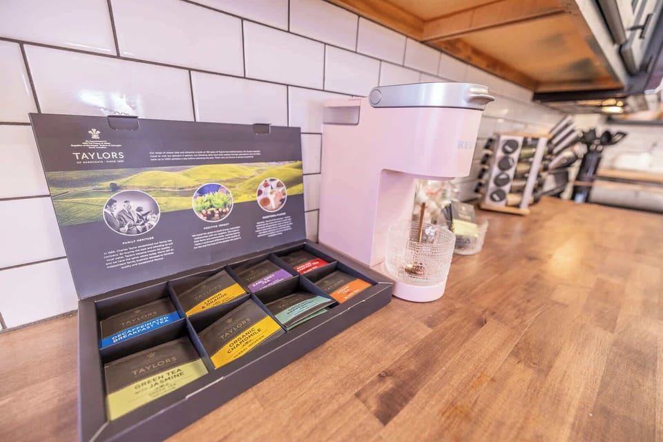 Start your day right with our complimentary coffee and Taylor's Tea selection in a charming kitchen setting!