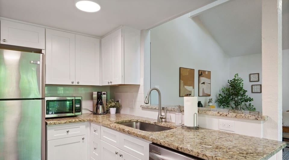 Full kitchen with all the essentials plus laundry room/ pantry