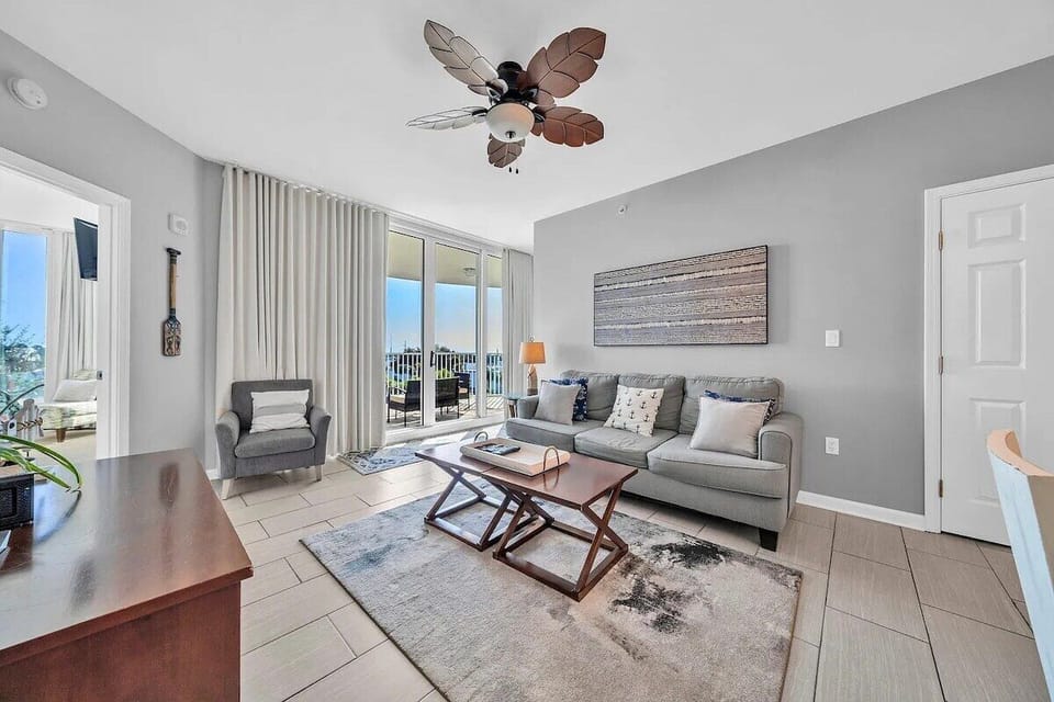 Living room with huge TV and sofa bed (sleeps 2) and access to balcony