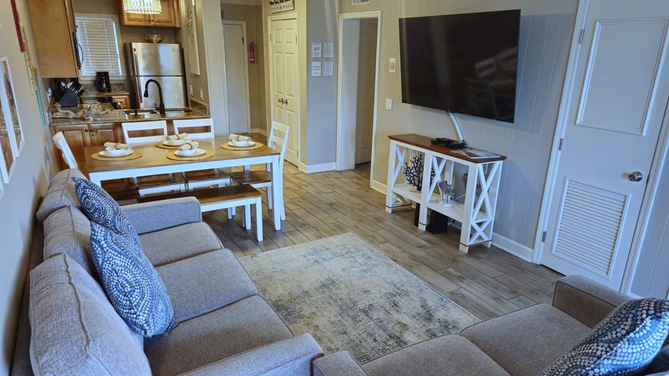 65" smart tv with all streaming options available and a DVD player.