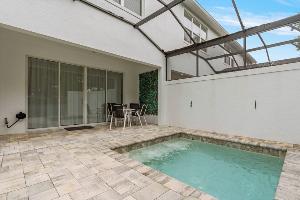 Unwind by the private pool amidst lush greenery, ideal for sunny days. The cozy patio boasts comfortable loungers, and the nearby playground offers fun for families, creating a perfect outdoor retreat for all.