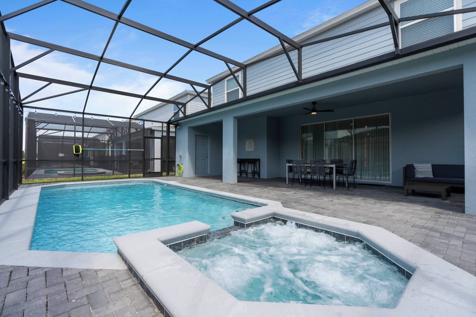 Step into your private oasis, where a sparkling blue pool invites you to unwind under a canopy of natural light. The soothing spa area, framed by sleek pavers, promises relaxation and rejuvenation after a day of adventure.