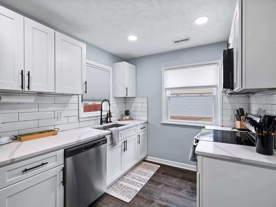 Bright kitchen w/ sleek finishes, stainless appliances & clean design
