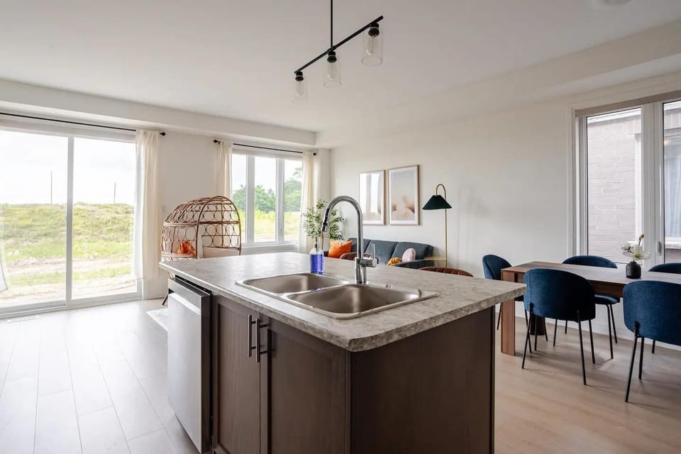 Open-concept living with natural light, a modern kitchen, and serene outdoor views.
