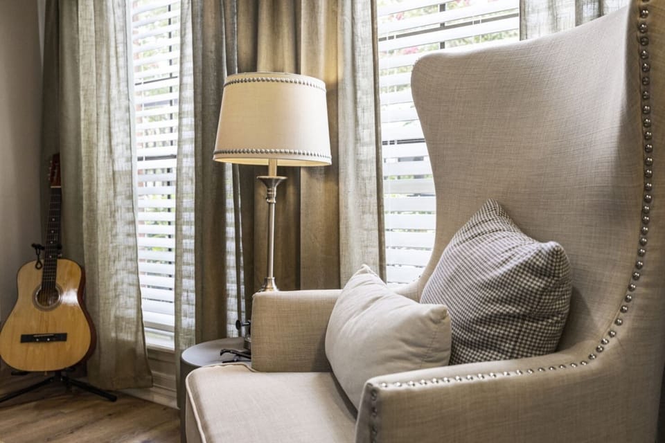 Unit 603 Cozy reading corner with guitar and natural light