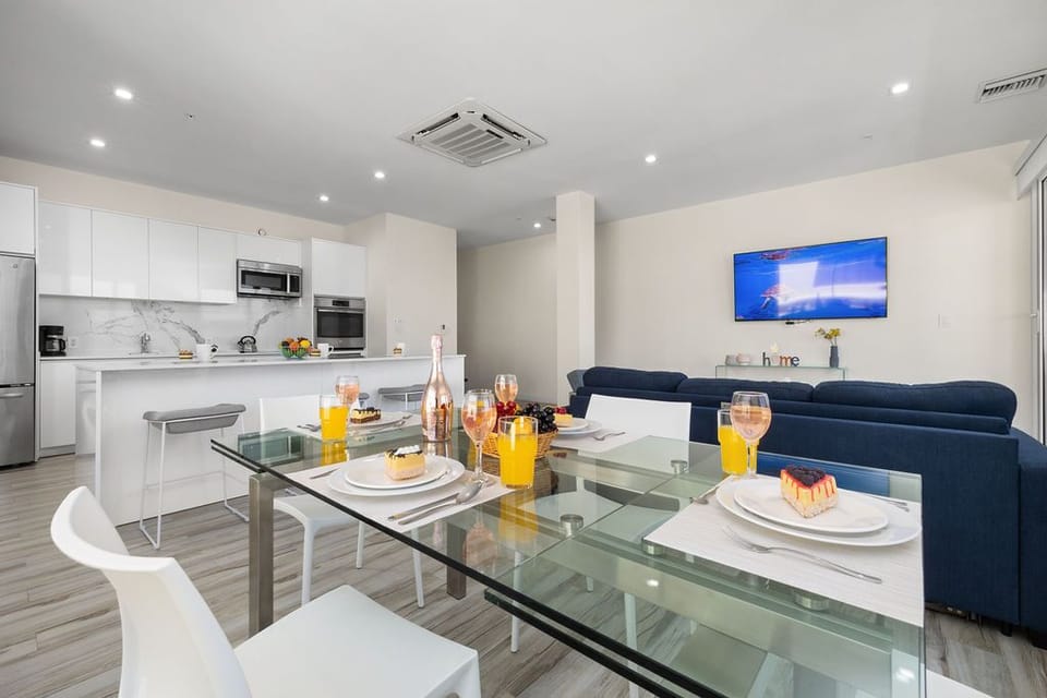 Step into this elegant dining area, where a chic glass table with seating for four takes center stage.