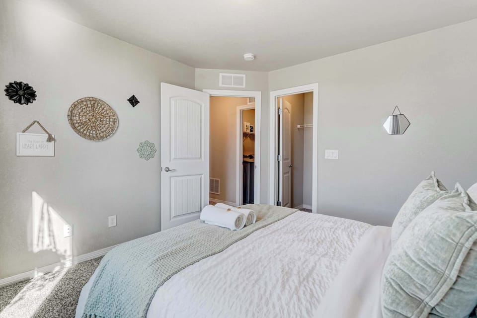 Unwind in this peaceful bedroom with a comfortable queen bed and calming decor, perfect for a restful night.