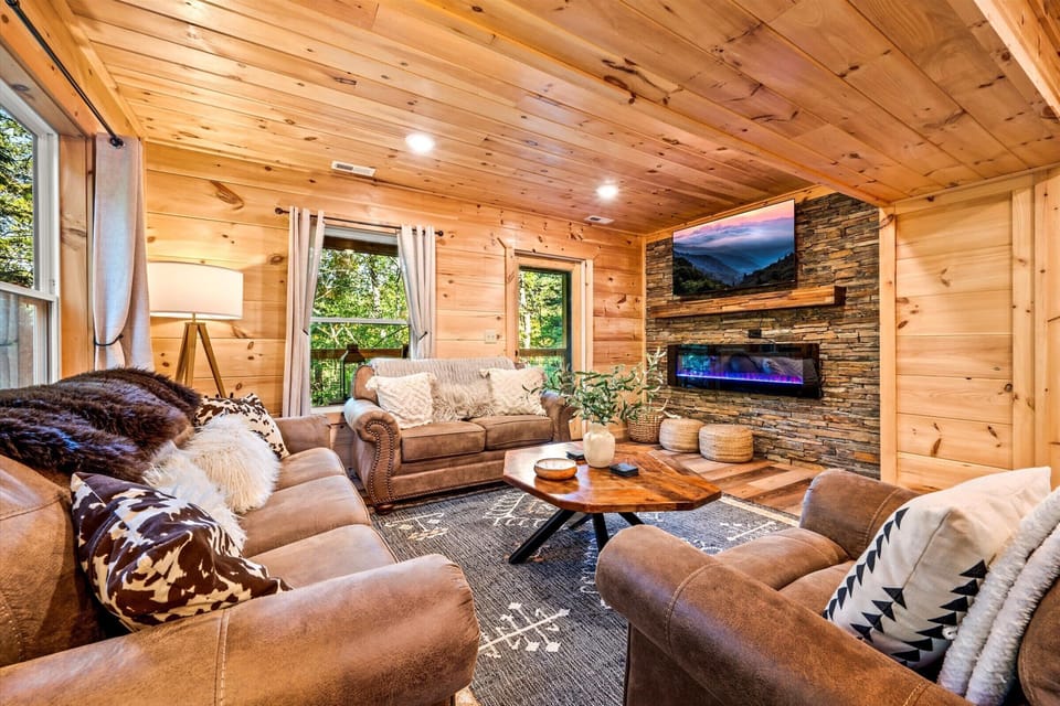 Unwind in the warm and cozy living area, complete with a HD TV and a fireplace for the perfect family gathering spot.