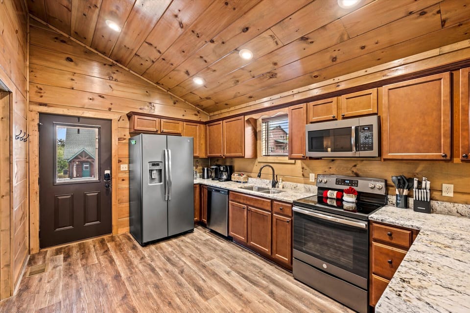 Modern kitchen with stainless steel appliances and plenty of counter space, perfect for preparing meals during your stay.