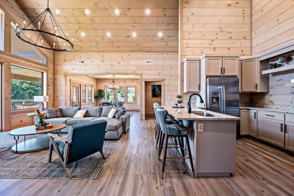 A view of the living room and kitchen on the main level. One master bedroom is located straight ahead through the doorframe. The other two bedrooms are behind you in this photo.