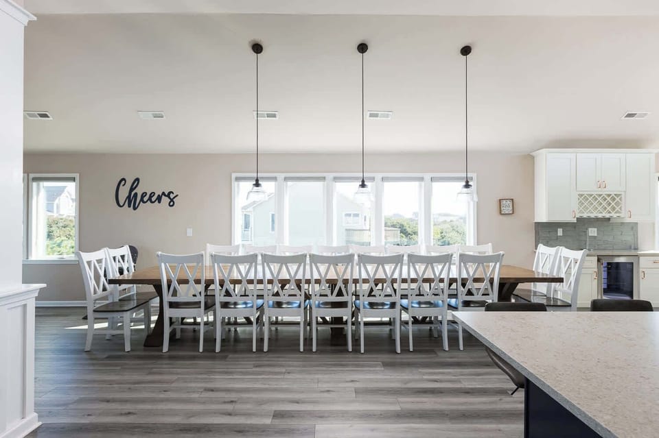 Bright and airy open-concept dining space with a dining table seating for 18