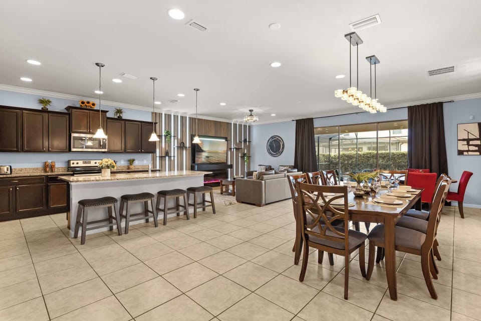 Dining Area: Gather for memorable meals around the spacious dining table, beautifully lit and positioned next to the open kitchen for effortless entertaining.