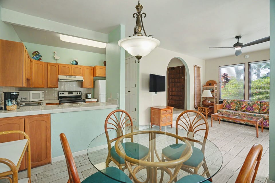 Settle into your open-concept retreat with a fully equipped kitchen, dining space, and cozy living area—all bathed in natural light and island-inspired decor.
