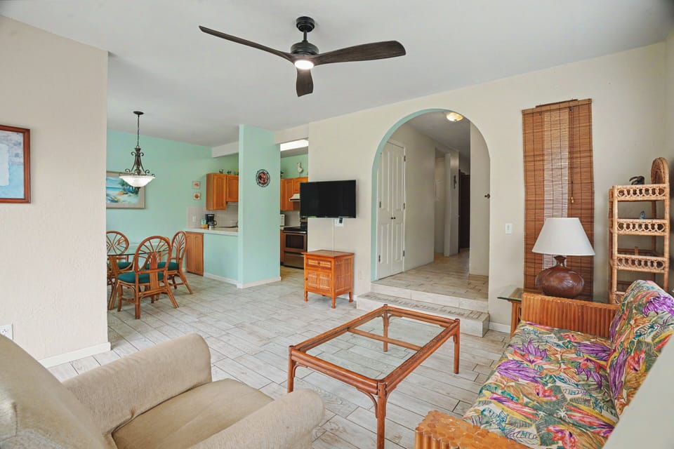 Relax in your bright, coastal-inspired living space with ceiling fans keeping you cool. The open layout connects you to the kitchen and dining area—perfect for vacation ease.