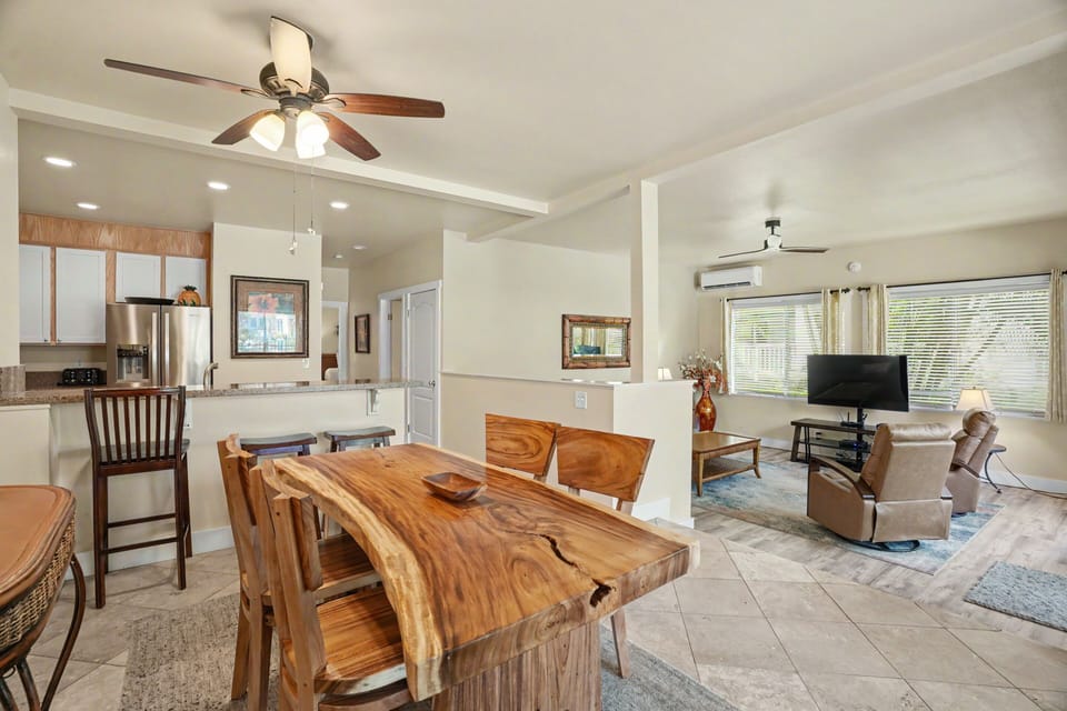 Unwind in this open-concept living space where natural wood and soft lighting create a warm, welcoming atmosphere perfect for your getaway.
