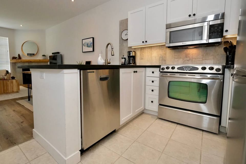 Kitchen - Fully equipped kitchen includes new cookware, plates, glasses for your stay.  The kitchen also features a black granite countertop, under counter lighting, coffee station, fridge, stove, toaster, dishwasher, and microwave.