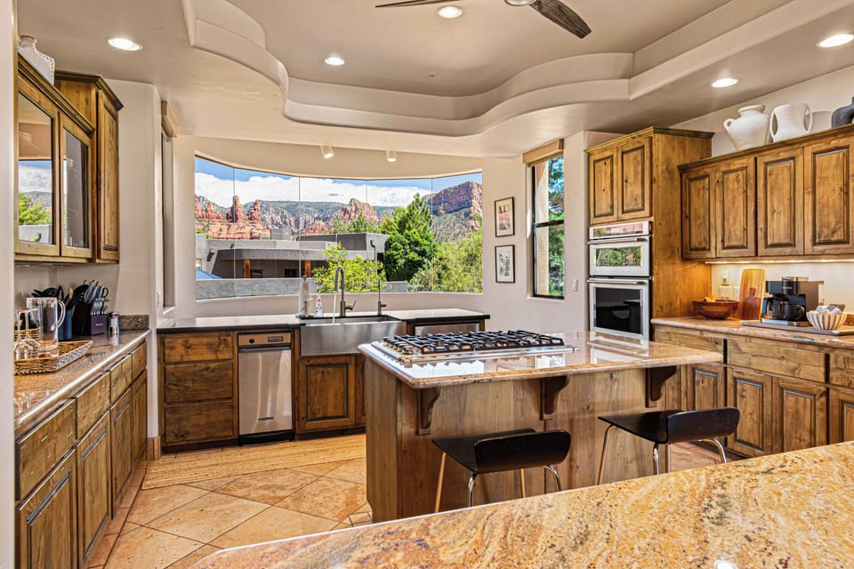 Expansive curved windows offering breathtaking views of Sedona's world-famous red rocks.