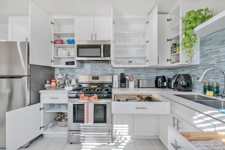
A spacious full kitchen with modern appliances, ample counter space, and style.