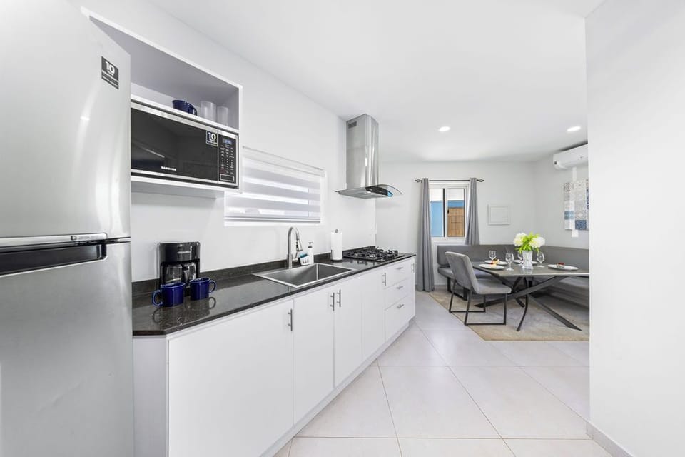Equipped with modern appliances, ample counter space, and an array of utensils, this kitchen is perfect for both simple meals and gourmet creations.
