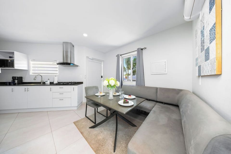 Relax in our property’s cozy dining and living area, designed with your comfort in mind. The dining area is elegantly set up for enjoyable meals, while the living space features soft, inviting seating that encourages you to sit back and relax.
