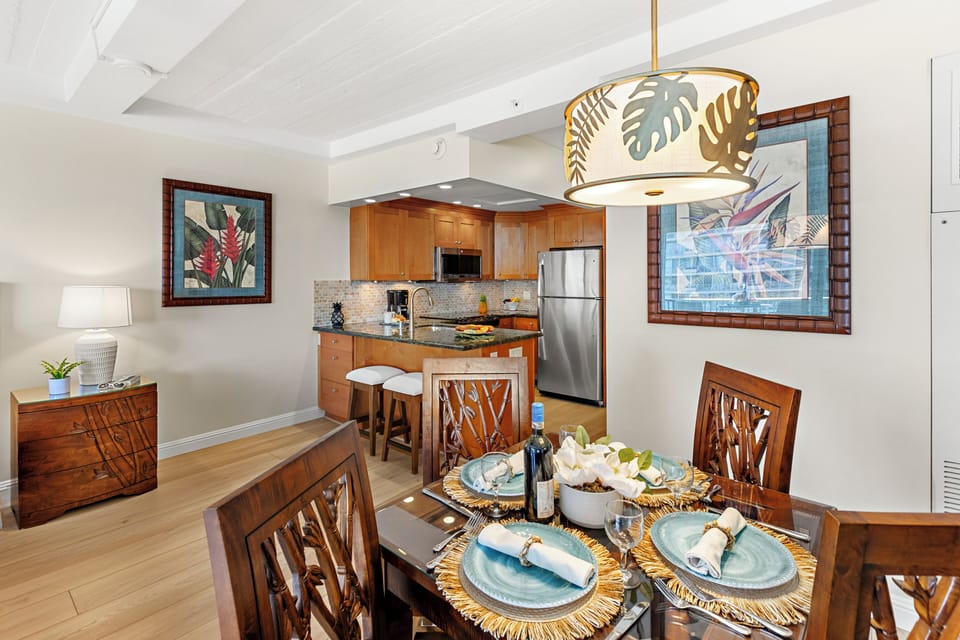 Step into your tropical-inspired dining space, where warm wood tones and island artwork create the perfect setting for memorable meals together.