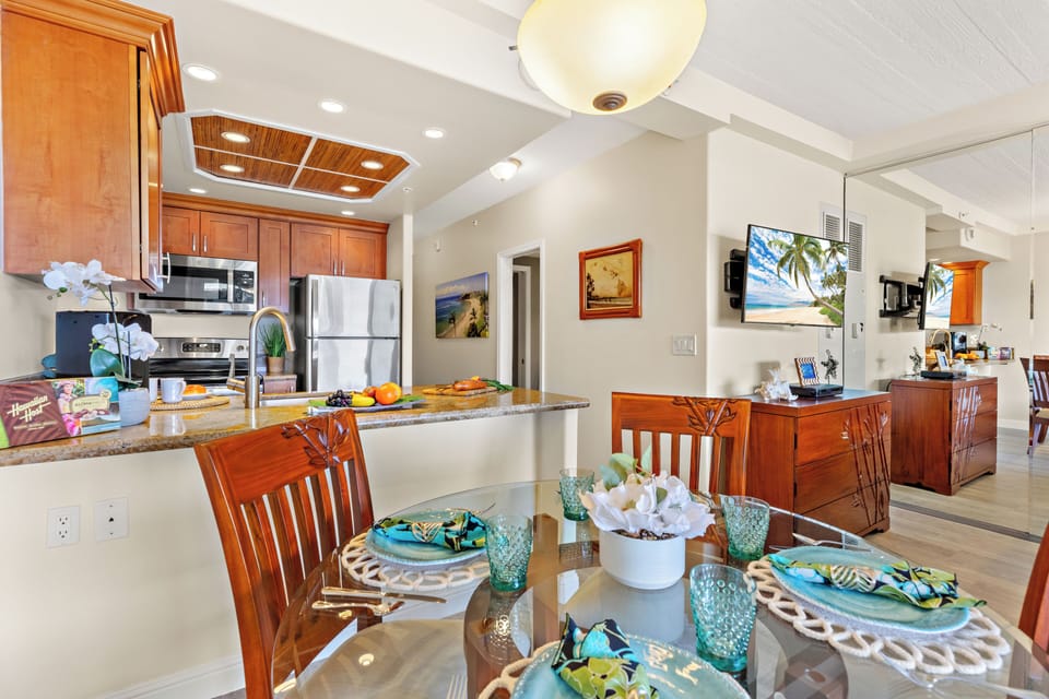 Bright and inviting open-concept kitchen featuring warm wood cabinetry, sleek granite countertops, and a spacious island that flows seamlessly into the living and dining areas. Perfect for entertaining or relaxing in comfort.