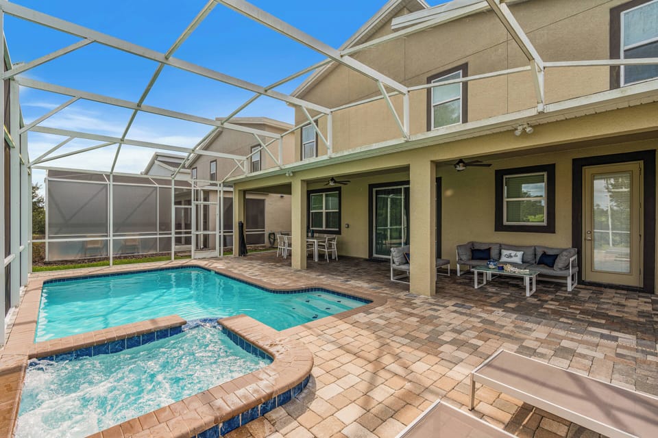 Step outside to your private oasis with a sparkling pool surrounded by elegant pavers and a screened enclosure. Relax on comfortable seating as you soak up the sunshine in this charming outdoor retreat.