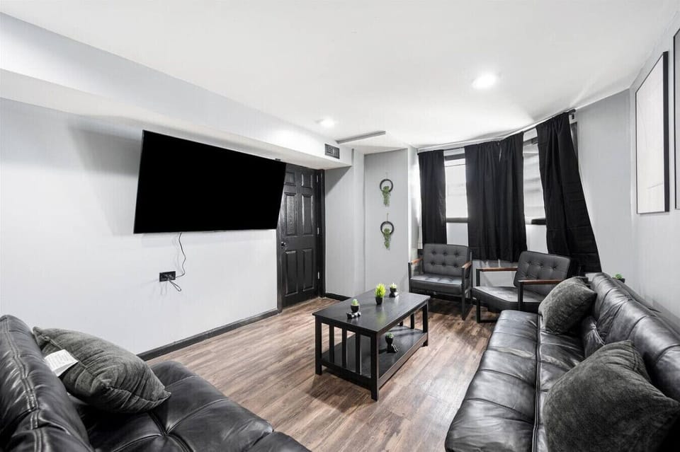 living room with 2 futons and 2 chairs - 65 inch TV