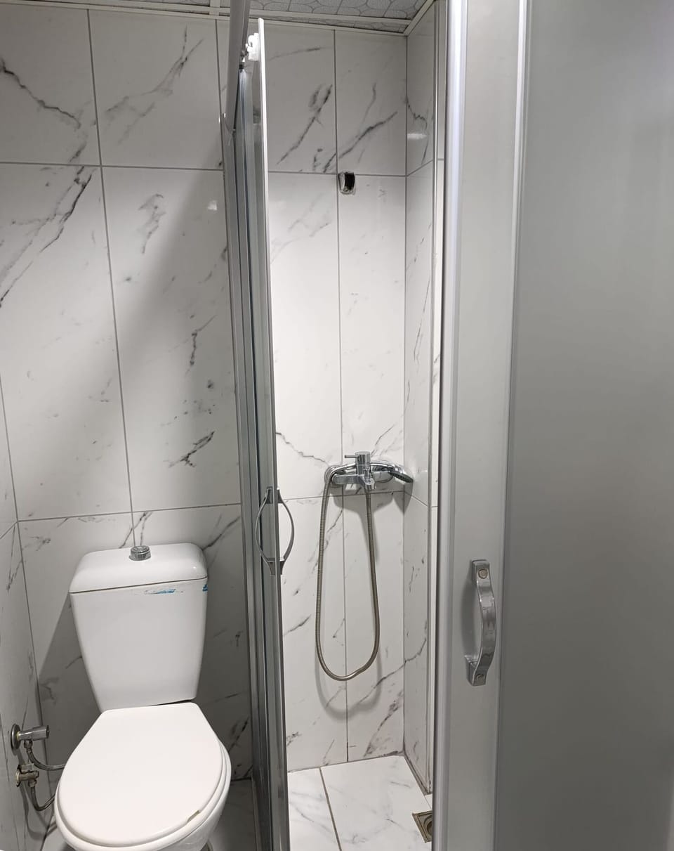 Shower, hair dryer, slippers, towels