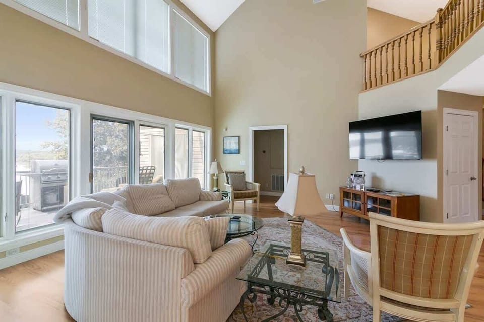 Spacious living area with huge white couch and bright natural light