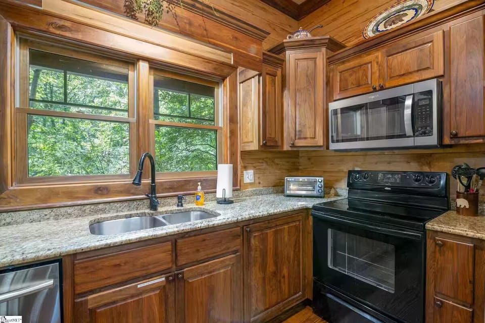 Fully-stocked kitchen with views overlooking the river.