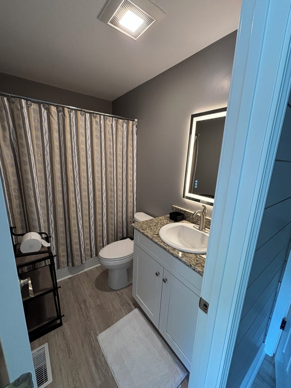 Bathroom includes Lighted Mirror and Shower Tub Combination