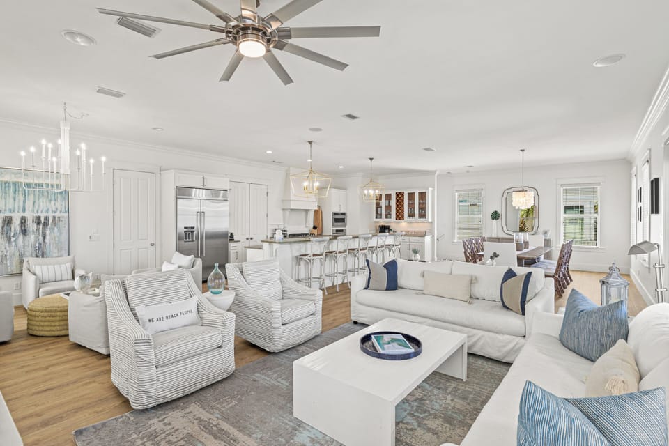 Relax in your bright, coastal-inspired living space with plush seating and open kitchen perfect for gathering.