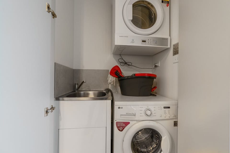 Conveniently located laundry room featuring both a washer and dryer, making it easy to keep your clothes fresh and clean during your stay.
