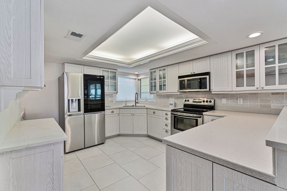 Fully stocked Kitchen with bar seating and brand new refrigerator and coffee bar