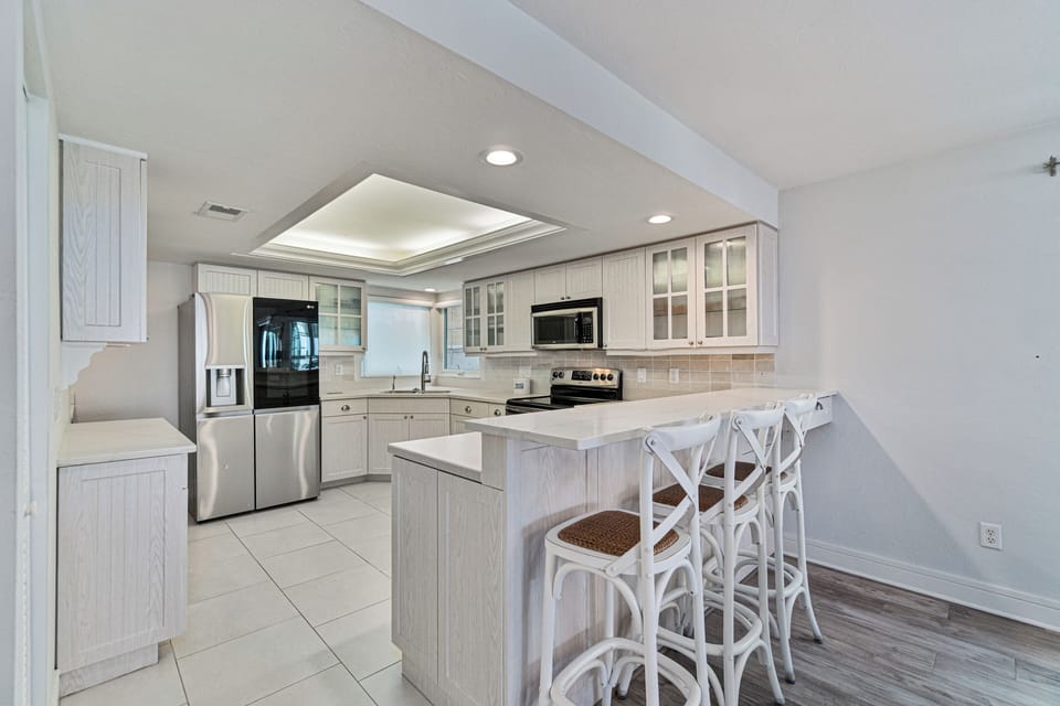 Fully stocked Kitchen with bar seating and brand new refrigerator