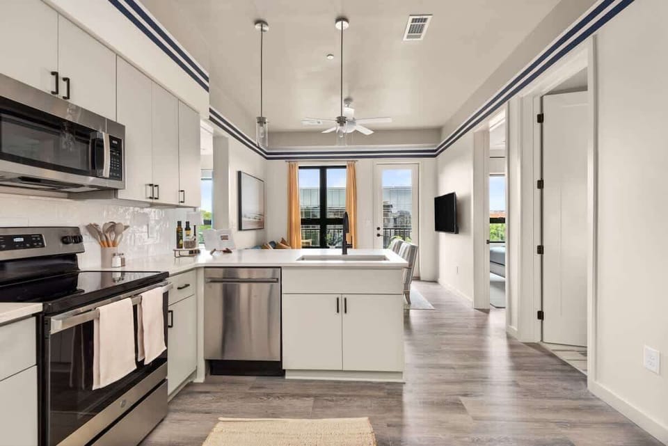 Modern kitchen with stainless steel appliances.