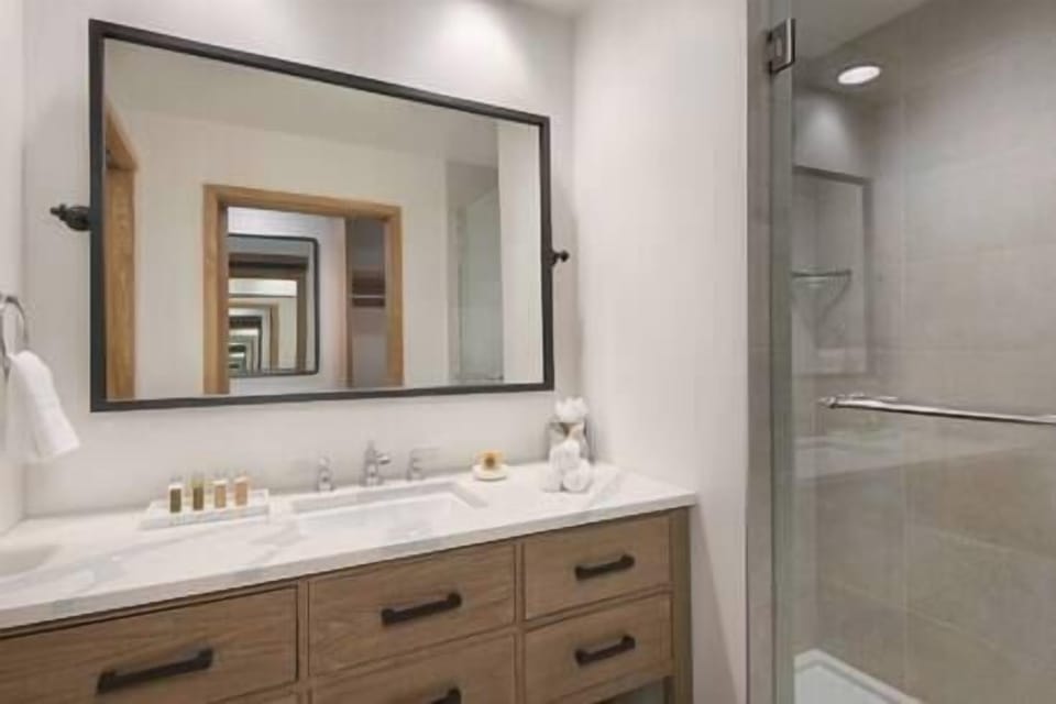 Refresh effortlessly with a sleek vanity and glass shower.