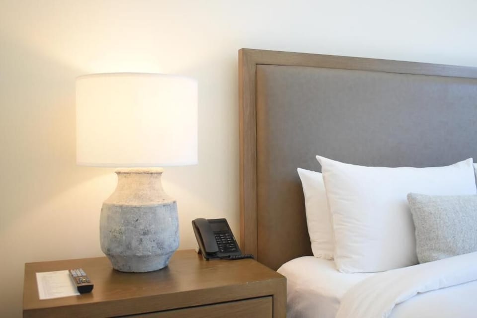 Wind down with soft lamplight and bedside essentials within reach.