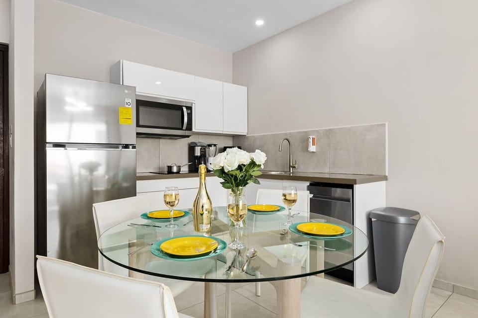 Dining area with microwave, refrigerator, oven, and sink.