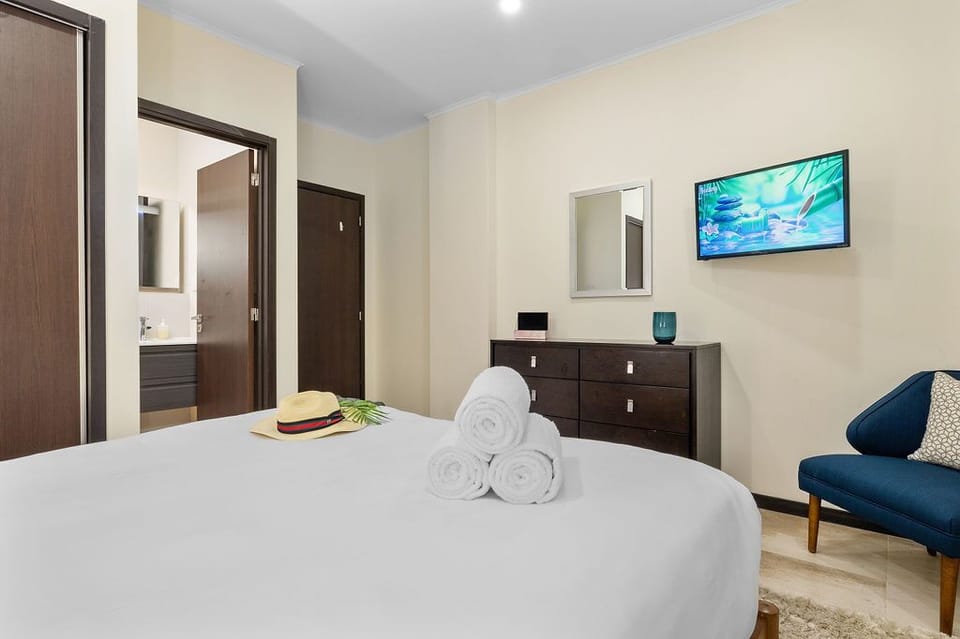 The wall-mounted TV provides a great entertainment option, making it a cozy retreat where you can relax and unwind.