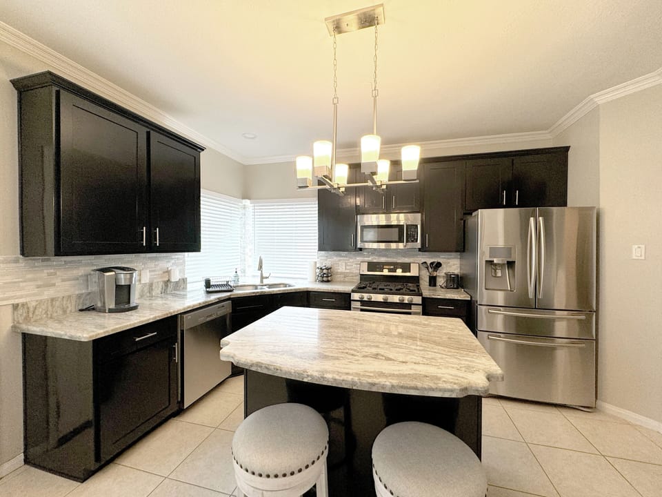 Fully-stocked kitchen with stainless steel appliances and keurig coffeemaker