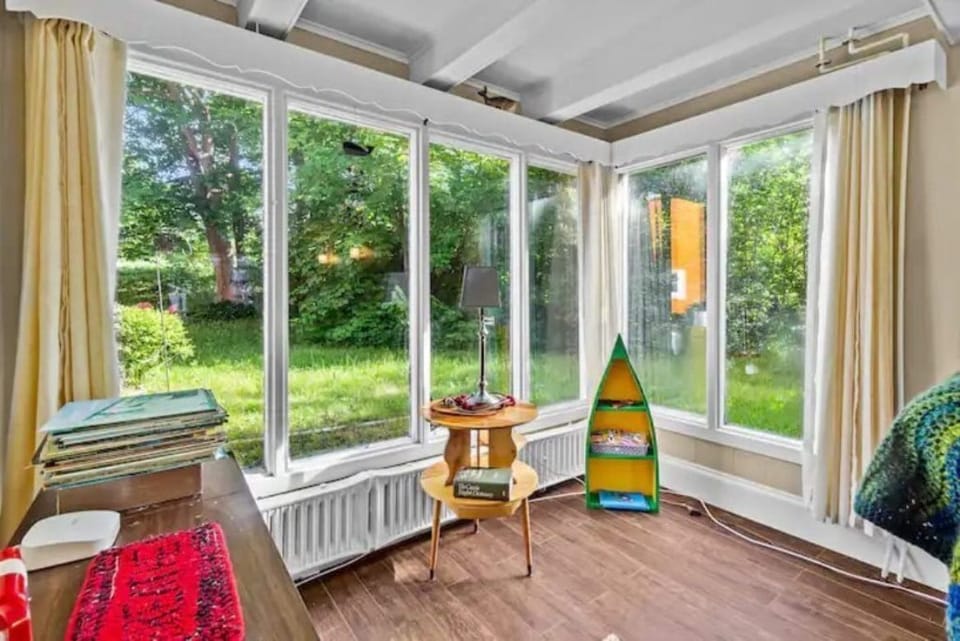 Our living room invites you to unwind and reconnect with nature's beauty. Whether it's sunrises or sunsets, our big window ensures every moment is filled with awe-inspiring views #Carbonear #SeasideHouse 