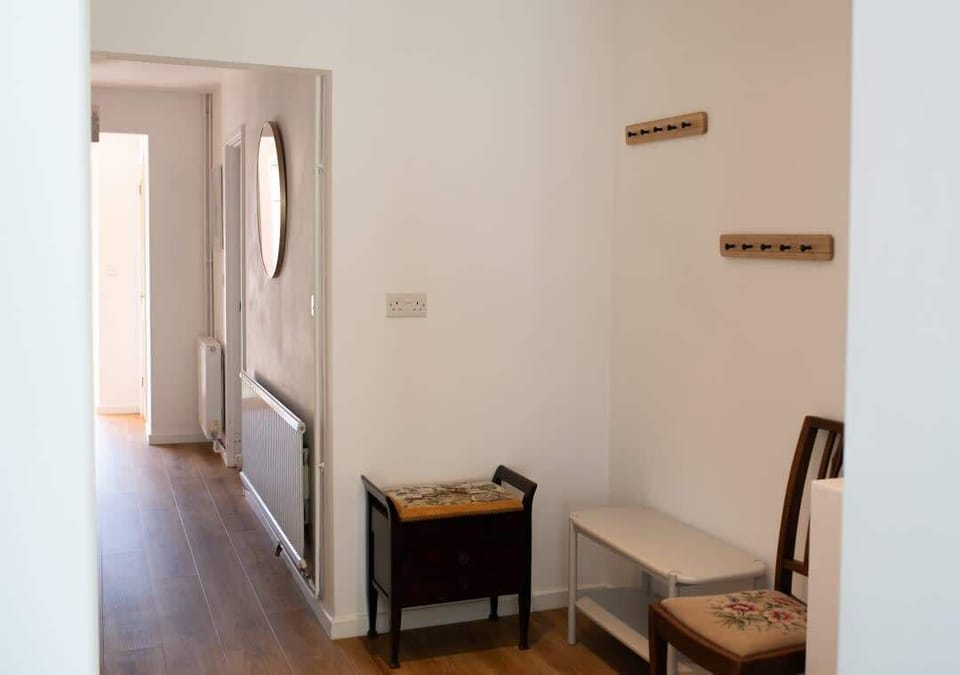 A well-lit corridor with a clean and welcoming design, providing a smooth transition between different areas of the home.