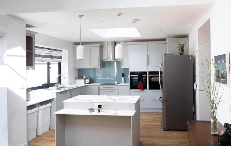 A modern and well-equipped kitchen showcasing sleek appliances, ample counter space, and a functional layout, perfect for cooking and entertaining.