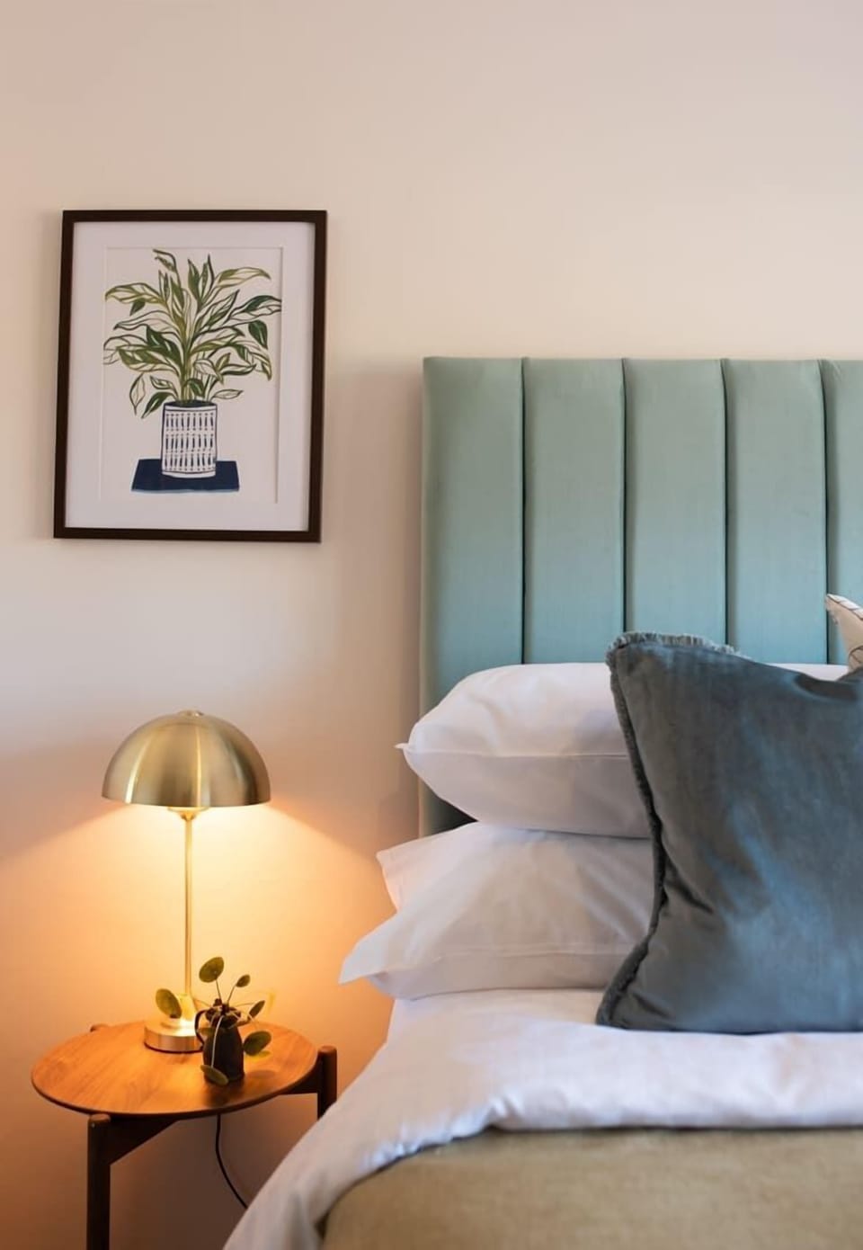 A bedside setup featuring a comfortable bed, a stylish lamp, and a functional nightstand, creating a cozy and practical sleeping area.