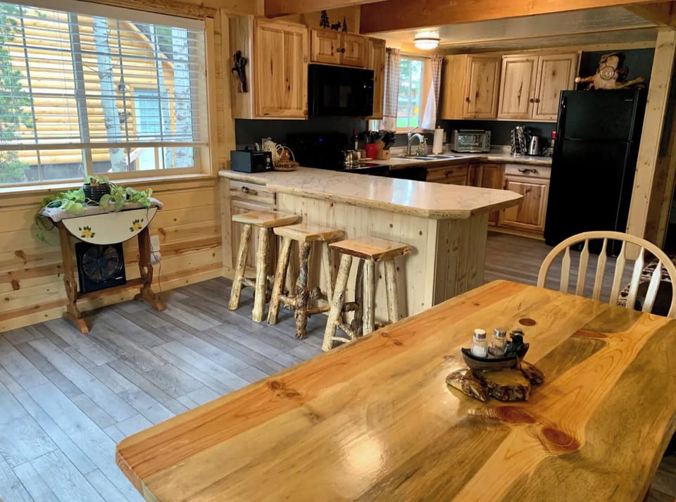 The dining table and kitchen. There is extra seating at the kitchen island.