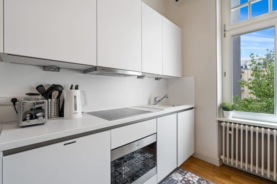 Fully equipped kitchen with all the essentials, including a coffee maker and kettle, perfect for preparing delicious meals.